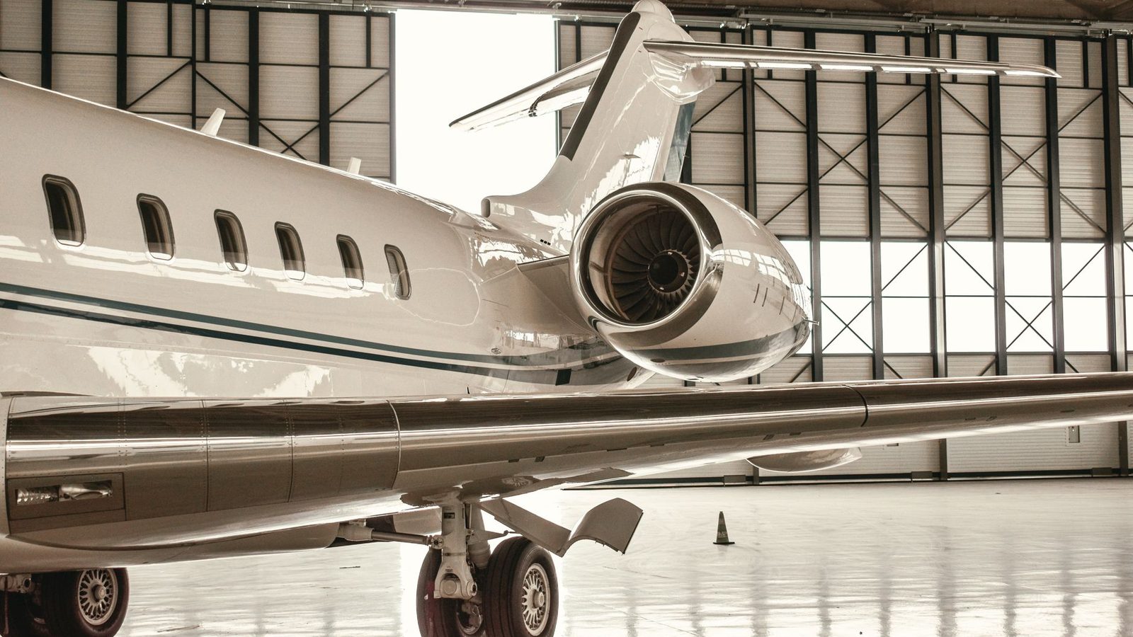 White large-cabin business jet in a hangar