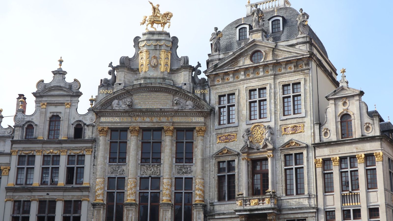 Grand Place in Brussels, stone facades under a blue sky