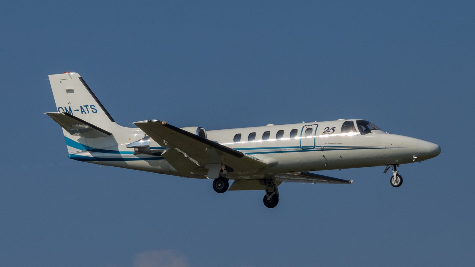 White Cessna Citation Bravo on approach against a blue sky, two rear engines, T-tail, gear down