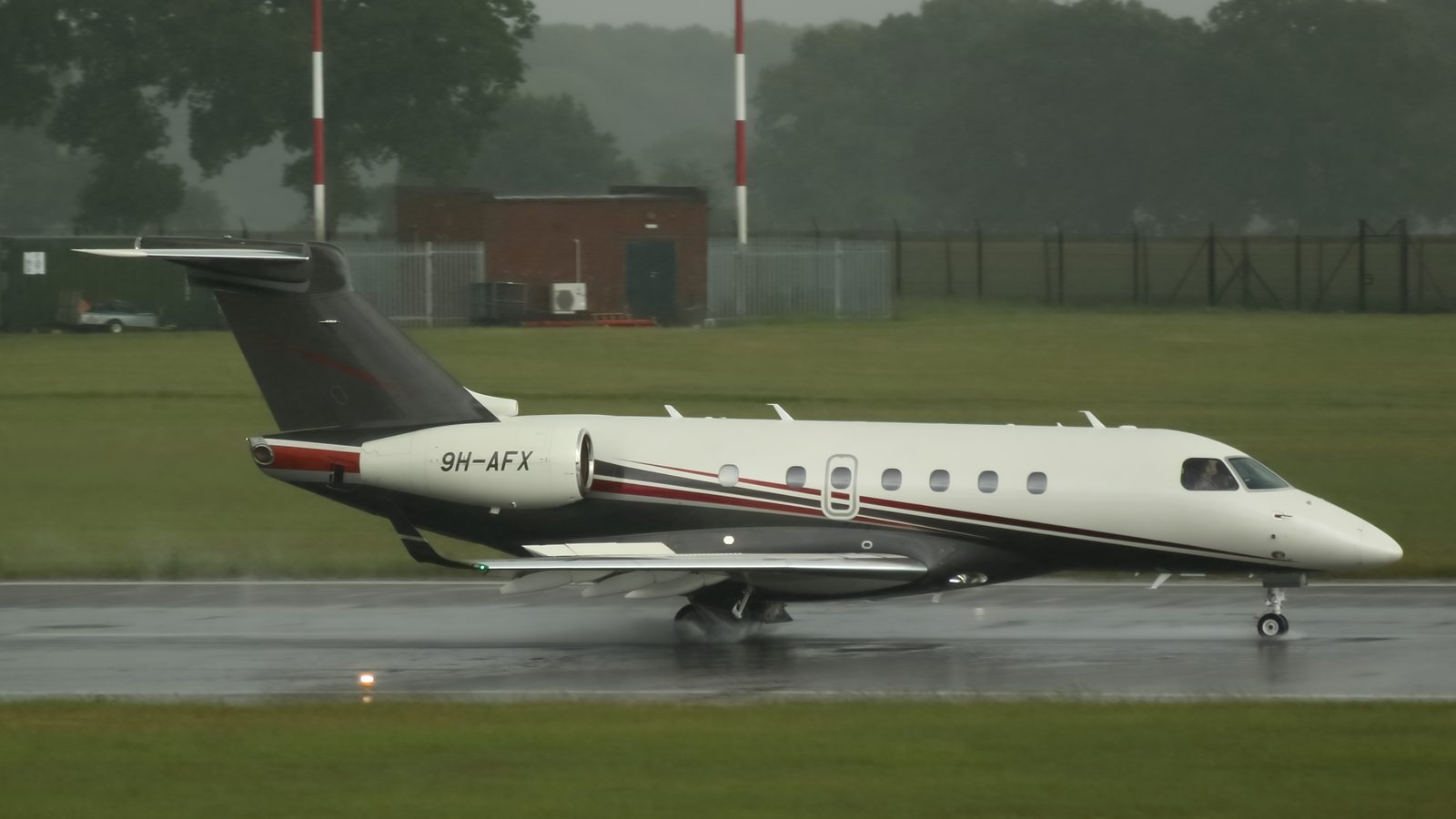 Flexjet Embraer Legacy 500 on a wet runway