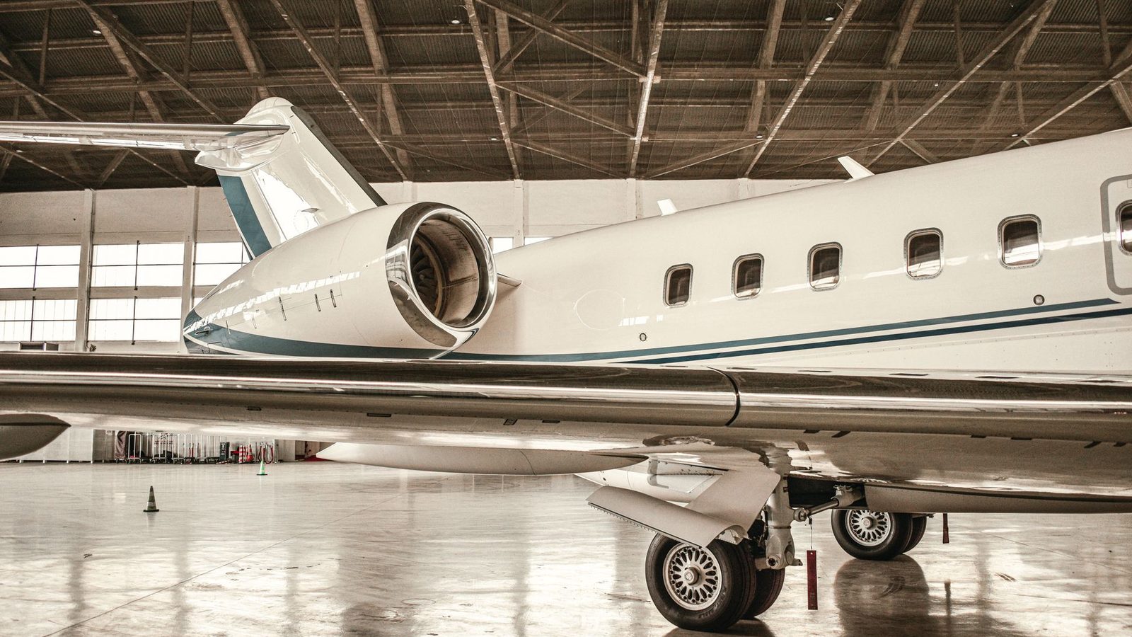 White large-cabin business jet in a hangar